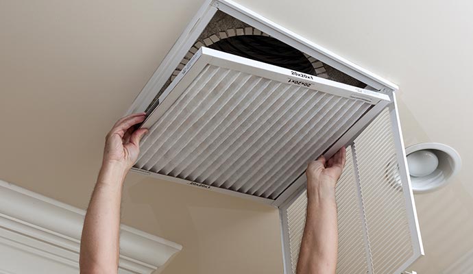 Technician replacing an hvac air filter