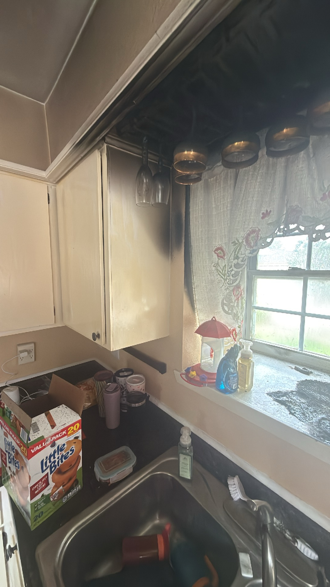 Detached vanity area undergoing structural water damage mitigation and localized drywall cutout inspections
