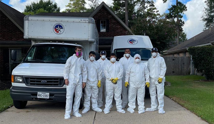 Fire Reconstruction Inc team standing infront of service vehicles